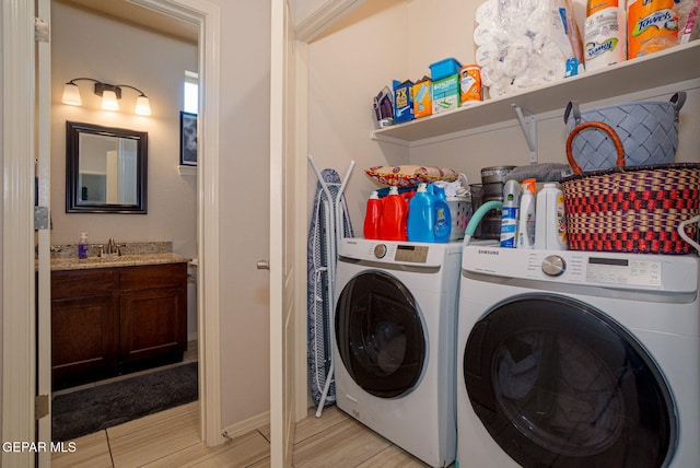 1916 William Caples St, El Paso, TX 79938 - laundry area featuring washer and dryer, light wood finished floors, and baseboards
