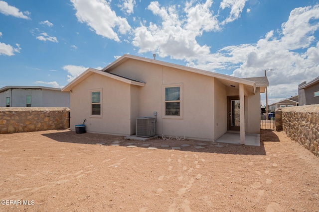 1916 William Caples St, El Paso, TX 79938 - back of house featuring central AC, stucco siding, a fenced backyard, and a patio area