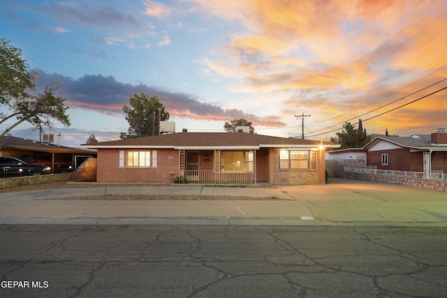 904 Apple Ln, El Paso, TX 79925 - ranch-style house with brick siding, a porch, and concrete driveway