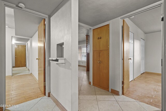 904 Apple Ln, El Paso, TX 79925 - hall with light tile patterned floors and baseboards