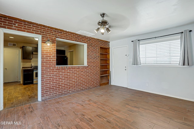 3408 Pierce Ave, El Paso, TX 79930 - empty room featuring a ceiling fan, wood finished floors, baseboards, and built in features