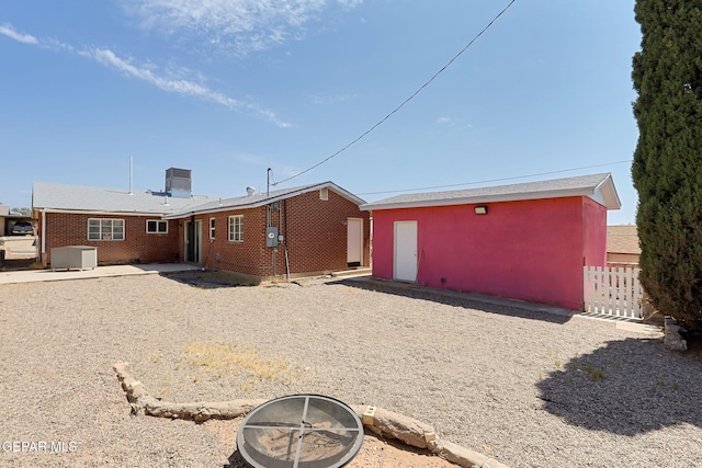 3408 Pierce Ave, El Paso, TX 79930 - rear view of property with an outdoor fire pit and brick siding