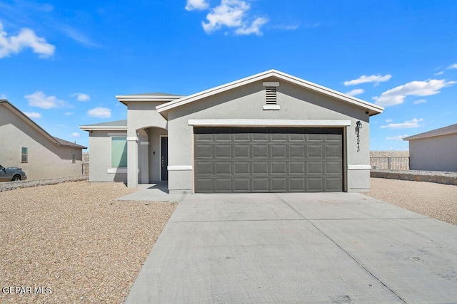 14573 Banana Yucca Ave, Horizon City, TX 79928 - ranch-style home featuring stucco siding, a garage, and driveway