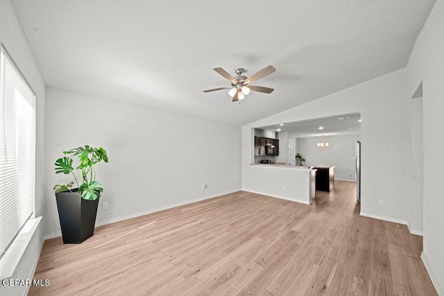 14573 Banana Yucca Ave, Horizon City, TX 79928 - unfurnished living room with vaulted ceiling, a ceiling fan, light wood-style flooring, and baseboards