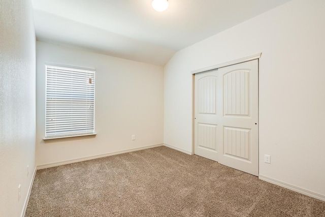 13852 Summer Wave Ave, El Paso, TX 79928 - unfurnished bedroom with carpet, vaulted ceiling, a closet, and baseboards