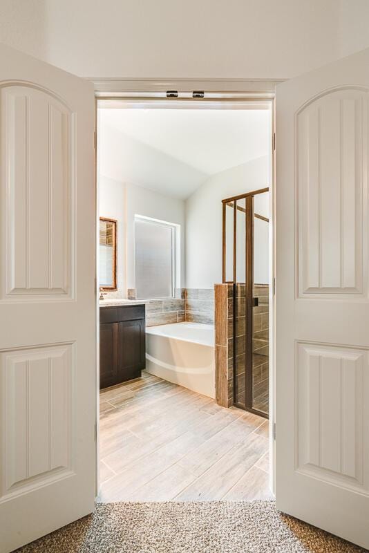 13852 Summer Wave Ave, El Paso, TX 79928 - full bathroom with a garden tub, vanity, and wood finished floors