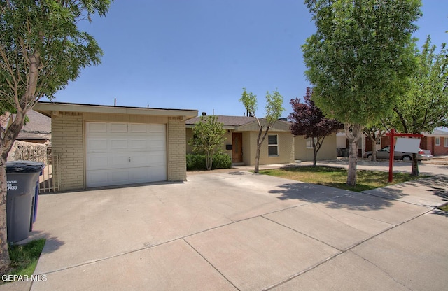 5814 Beaumont Pl, El Paso, TX 79912 - single story home featuring driveway, brick siding, and a detached garage