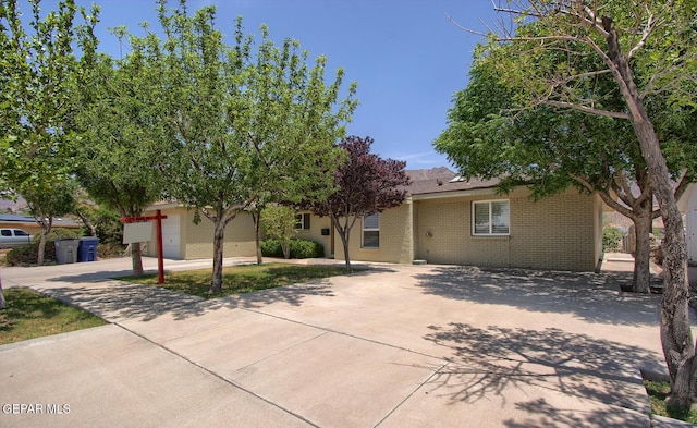 5814 Beaumont Pl, El Paso, TX 79912 - view of property hidden behind natural elements with concrete driveway and brick siding