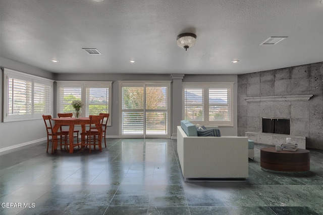 5814 Beaumont Pl, El Paso, TX 79912 - living room with baseboards, plenty of natural light, a tile fireplace, and recessed lighting