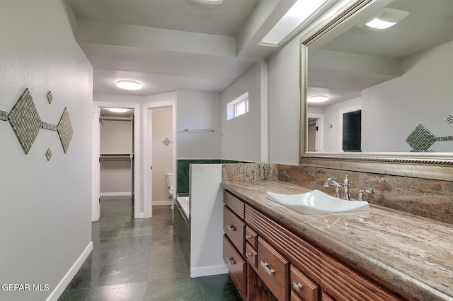 5814 Beaumont Pl, El Paso, TX 79912 - full bathroom with vanity, baseboards, a spacious closet, and tile patterned flooring