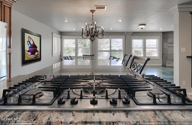 5814 Beaumont Pl, El Paso, TX 79912 - detailed view of stainless steel gas stovetop, brown cabinetry, a chandelier, and recessed lighting