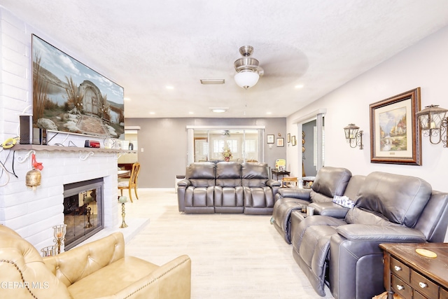 10605 Park View Cir, El Paso, TX 79935 - living room with a ceiling fan, light wood-style floors, a fireplace, and recessed lighting