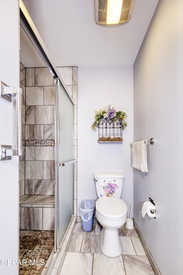 10605 Park View Cir, El Paso, TX 79935 - full bathroom featuring toilet, a stall shower, marble look tiles, and baseboards