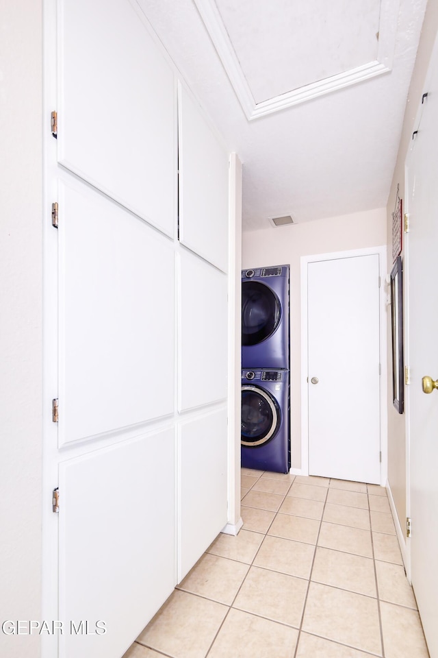 10605 Park View Cir, El Paso, TX 79935 - hallway with estacked washer and dryer and light tile patterned floors