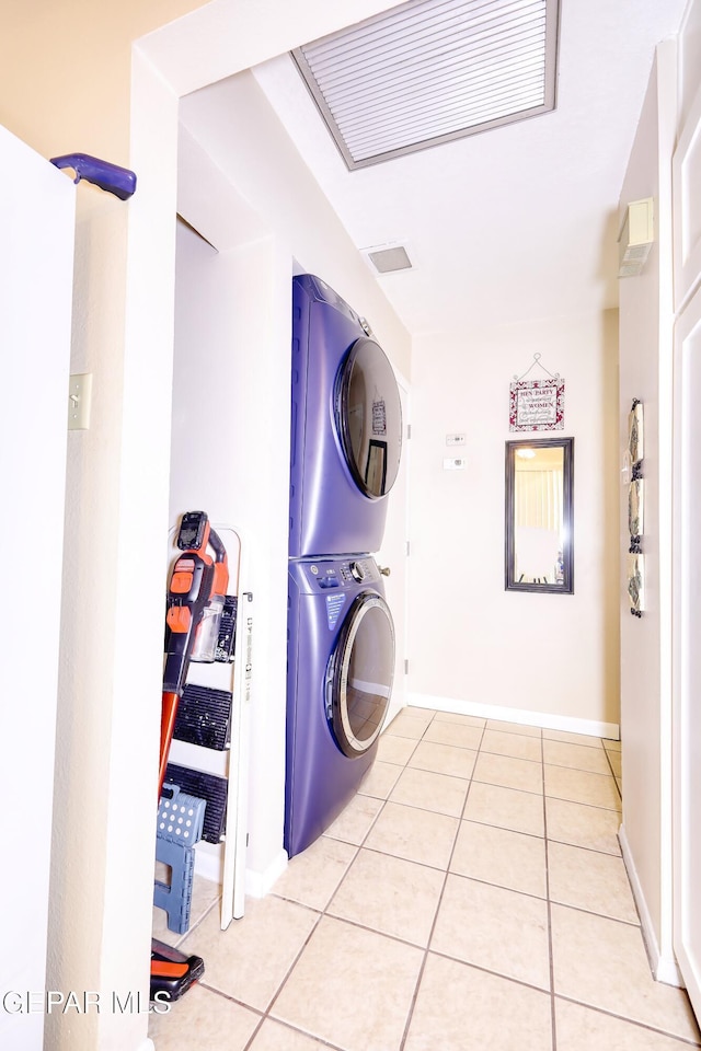 10605 Park View Cir, El Paso, TX 79935 - washroom featuring estacked washer and dryer, light tile patterned floors, and baseboards