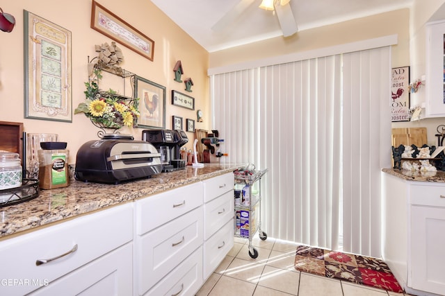 10605 Park View Cir, El Paso, TX 79935 - kitchen featuring light tile patterned flooring, white cabinetry, light stone countertops, and ceiling fan