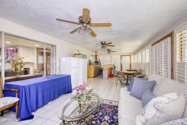 10605 Park View Cir, El Paso, TX 79935 - living room featuring a ceiling fan, tile patterned flooring, and a textured ceiling