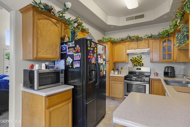 14407 Ocean Point Ln, El Paso, TX 79938 - kitchen with appliances with stainless steel finishes, under cabinet range hood, a sink, light countertops, and light tile patterned floors