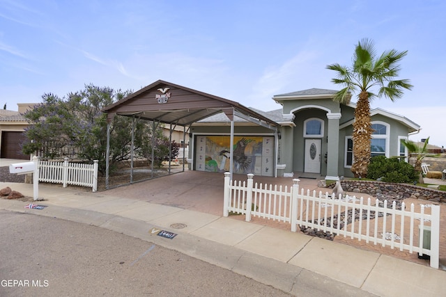 14407 Ocean Point Ln, El Paso, TX 79938 - view of front facade with driveway, stucco siding, a fenced front yard, and a carport