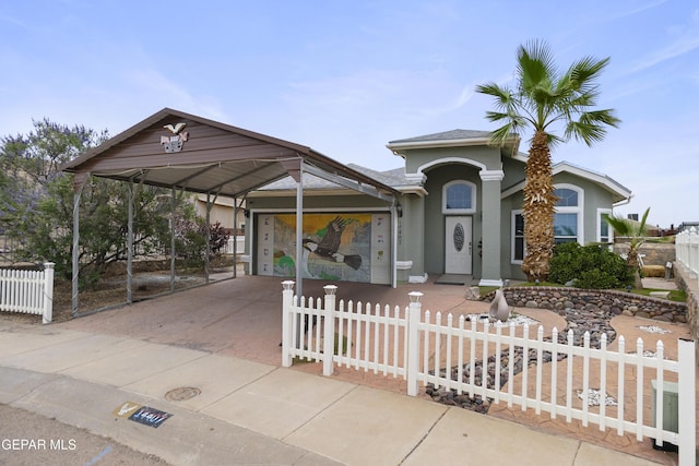 14407 Ocean Point Ln, El Paso, TX 79938 - view of front of property featuring driveway, stucco siding, a carport, and a fenced front yard