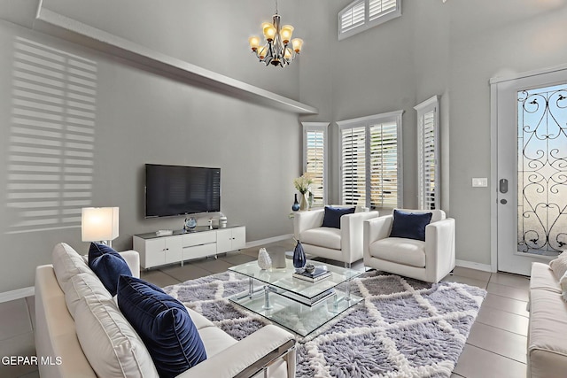 3129 Spring Willow, El Paso, TX 79938 - tiled living area featuring a chandelier, a towering ceiling, and baseboards