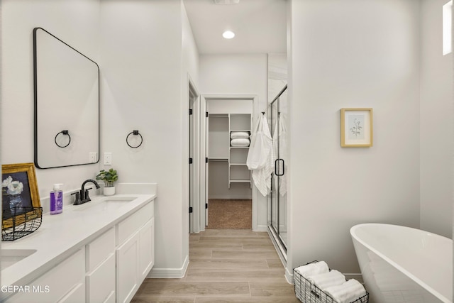 13824 Paseo Bosque Ave, El Paso, TX 79928 - full bathroom featuring double vanity, a shower stall, a freestanding bath, baseboards, and recessed lighting
