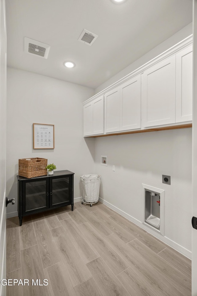 13824 Paseo Bosque Ave, El Paso, TX 79928 - washroom with electric dryer hookup, hookup for a washing machine, cabinet space, baseboards, and light wood finished floors