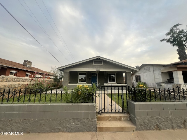 3208 Tularosa Ave, El Paso, TX 79903 - view of front of house featuring covered porch, a fenced front yard, a gate, and brick siding