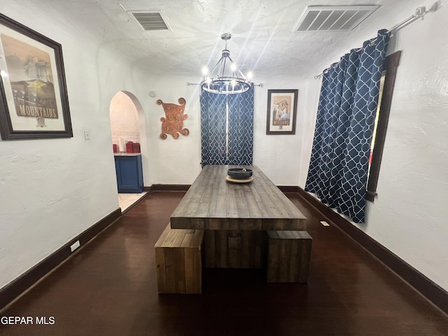 3208 Tularosa Ave, El Paso, TX 79903 - dining room featuring a chandelier, arched walkways, baseboards, and dark wood-style floors