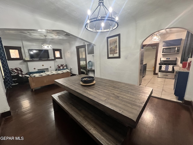 3208 Tularosa Ave, El Paso, TX 79903 - dining area featuring a chandelier, hardwood / wood-style flooring, and arched walkways