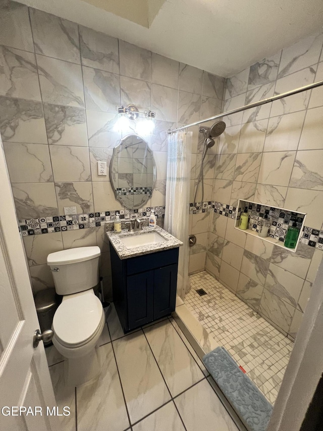 3208 Tularosa Ave, El Paso, TX 79903 - bathroom with vanity, toilet, a stall shower, marble finish flooring, and tile walls
