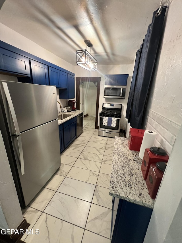 3208 Tularosa Ave, El Paso, TX 79903 - kitchen with stainless steel appliances, blue cabinets, light marble finish floors, and a sink