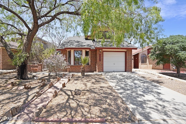 11765 Queens Garden Cir, El Paso, TX 79936 - view of front of house featuring brick siding, driveway, and a garage