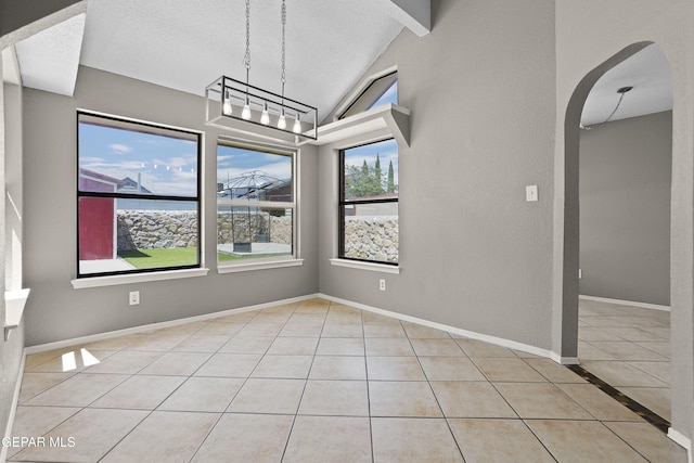11765 Queens Garden Cir, El Paso, TX 79936 - unfurnished dining area featuring tile patterned floors, arched walkways, and a textured ceiling