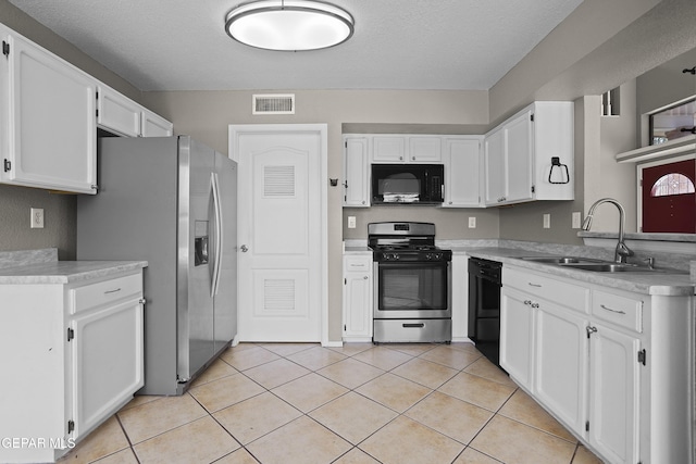 11765 Queens Garden Cir, El Paso, TX 79936 - kitchen with black appliances, white cabinetry, light countertops, light tile patterned floors, and a textured ceiling