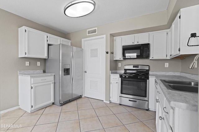 11765 Queens Garden Cir, El Paso, TX 79936 - kitchen with appliances with stainless steel finishes, white cabinetry, light countertops, and light tile patterned flooring