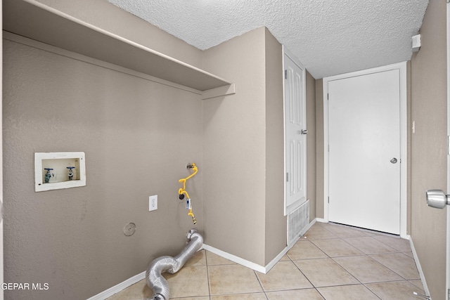 11765 Queens Garden Cir, El Paso, TX 79936 - laundry area with hookup for a washing machine, a textured ceiling, light tile patterned floors, and hookup for a gas dryer