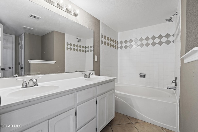 11765 Queens Garden Cir, El Paso, TX 79936 - bathroom featuring double vanity, tile patterned flooring, bathing tub / shower combination, a textured wall, and a textured ceiling