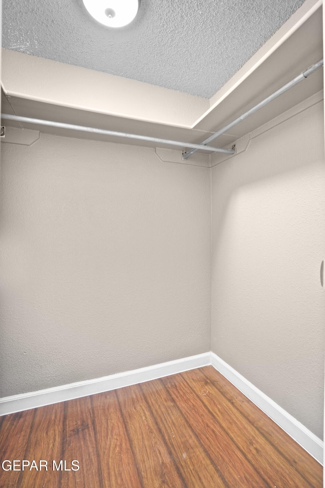 11765 Queens Garden Cir, El Paso, TX 79936 - walk in closet with wood finished floors