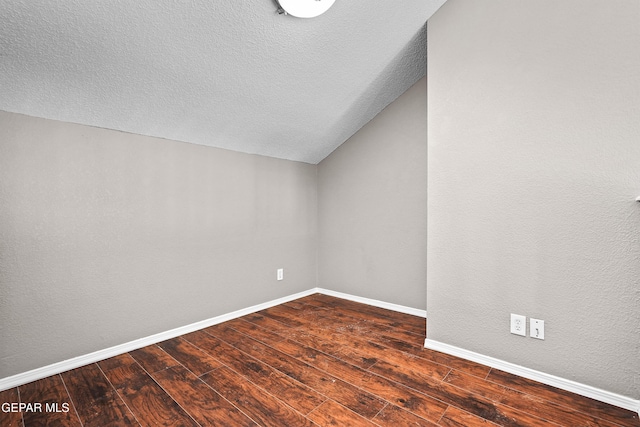 11765 Queens Garden Cir, El Paso, TX 79936 - spare room with dark wood-type flooring, lofted ceiling, and a textured ceiling