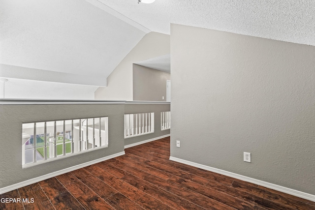 11765 Queens Garden Cir, El Paso, TX 79936 - spare room featuring wood finished floors, lofted ceiling, a textured wall, and a textured ceiling