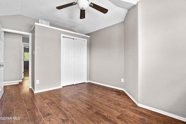 11765 Queens Garden Cir, El Paso, TX 79936 - unfurnished bedroom with dark wood-style floors, lofted ceiling, a closet, and ceiling fan