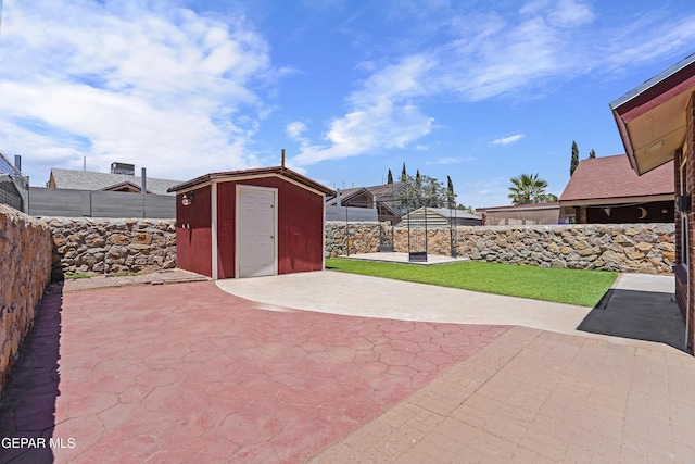 11765 Queens Garden Cir, El Paso, TX 79936 - fenced backyard featuring a shed and a patio