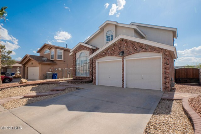 1321 Amber Morgan Dr, El Paso, TX 79936 - view of front of home featuring brick siding, driveway, and an attached garage