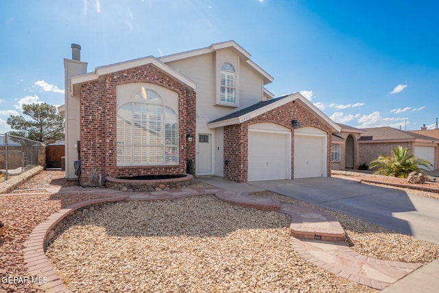 1321 Amber Morgan Dr, El Paso, TX 79936 - view of front facade with brick siding, driveway, an attached garage, and a chimney