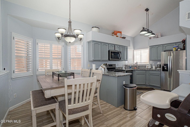 1321 Amber Morgan Dr, El Paso, TX 79936 - kitchen with appliances with stainless steel finishes, gray cabinetry, a chandelier, high vaulted ceiling, and a sink