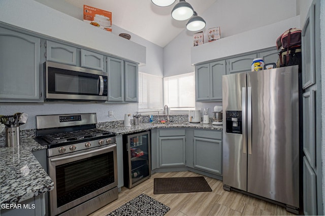 1321 Amber Morgan Dr, El Paso, TX 79936 - kitchen featuring stainless steel appliances, beverage cooler, stone counters, a sink, and high vaulted ceiling