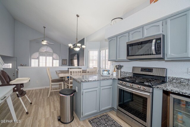 1321 Amber Morgan Dr, El Paso, TX 79936 - kitchen featuring stainless steel appliances, beverage cooler, a peninsula, lofted ceiling, and plenty of natural light