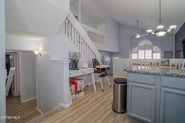 1321 Amber Morgan Dr, El Paso, TX 79936 - kitchen featuring light wood-style floors, a chandelier, decorative light fixtures, ceiling fan, and light stone counters