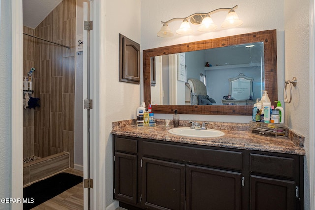 1321 Amber Morgan Dr, El Paso, TX 79936 - ensuite bathroom with a tile shower, vanity, and baseboards